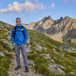 John Bragg portrait depicting solo travel while on a hike in the Swiss Alps.