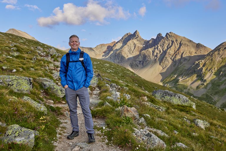 John Bragg portrait depicting solo travel while on a hike in the Swiss Alps.