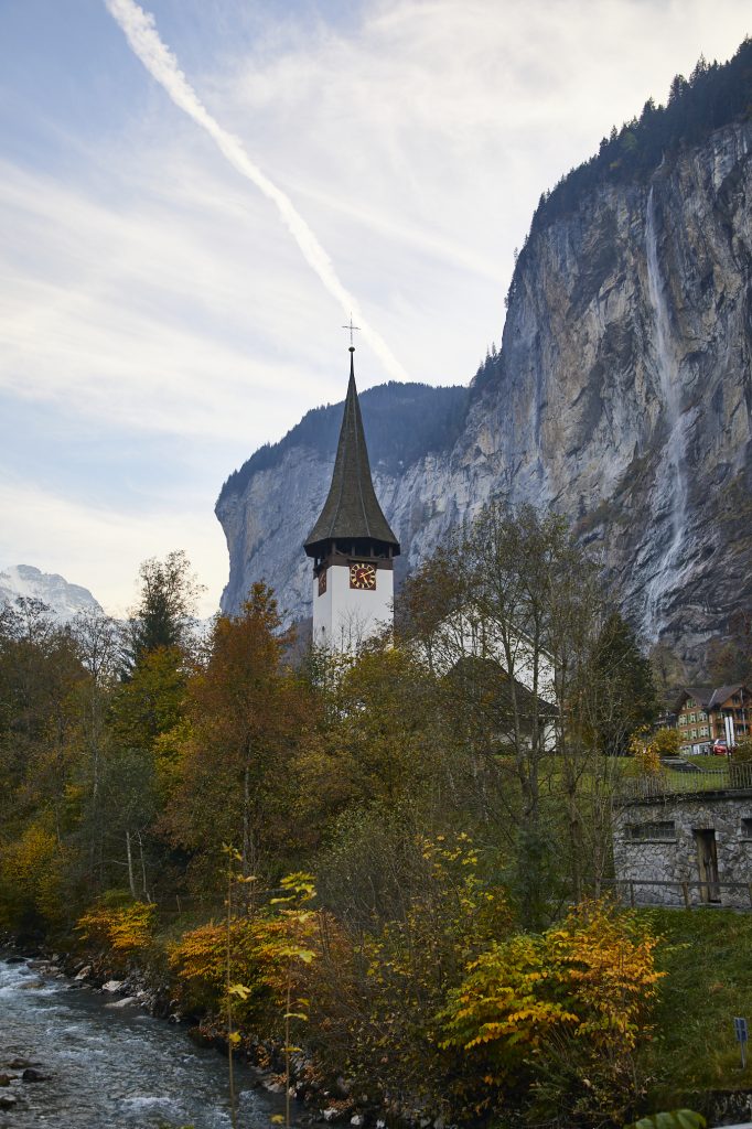 One of the best things to do in Lauterbrunnen is to find great photo spots for the church in Lauterbrunnen, Switzerland. It's fun to make sure the Staubbach Falls waterfall is in the background