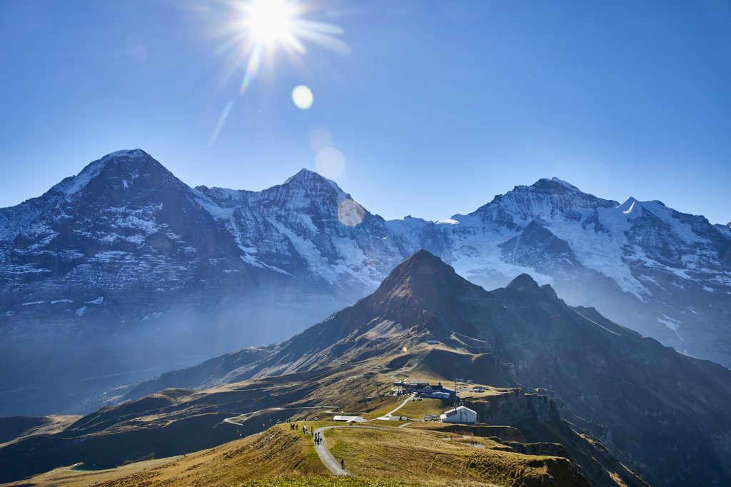 Breathtaking mountain scenery with snow-covered peaks, sunny sky, ideal for travel and exploration.